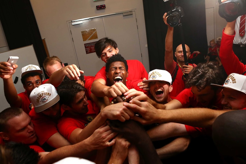 Perth Wildcats celebrate with the trophy after winning the NBL title against New Zealand Breakers.