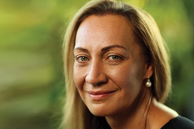 a woman with long blonde hair, smiling