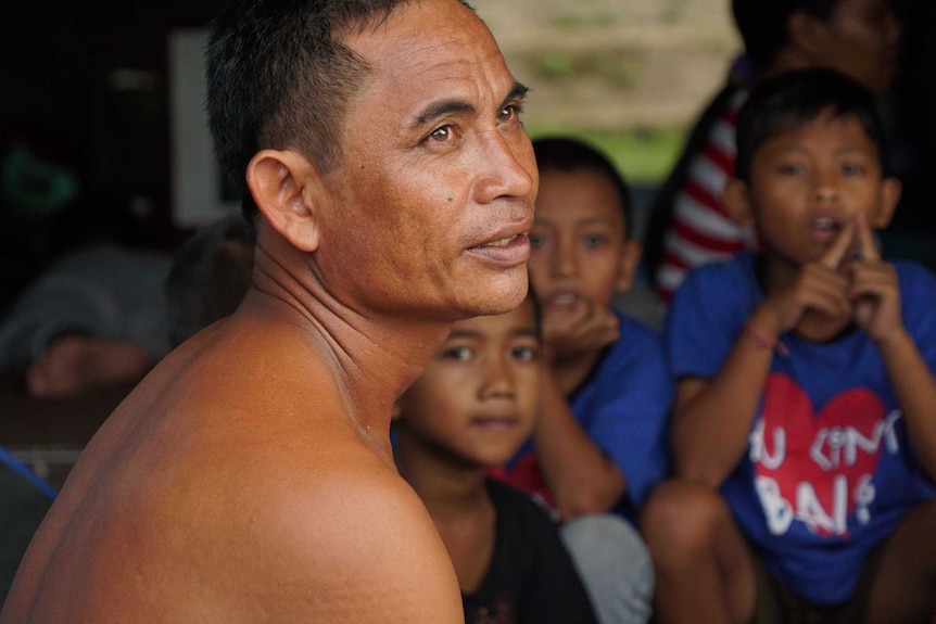 Construction worker Mayan Masta came to Bali's evacuation camp with his wife and two boys.