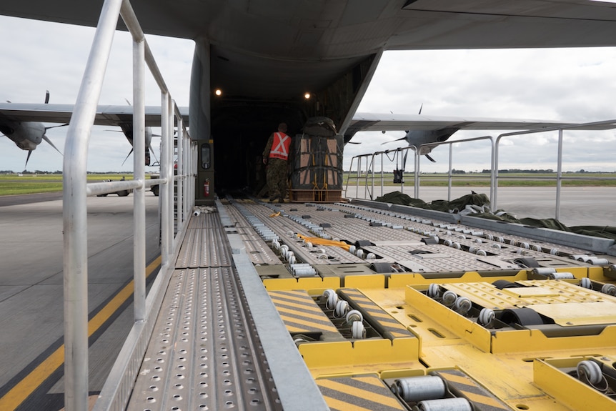 Ground crews load the RAAF Hercules.