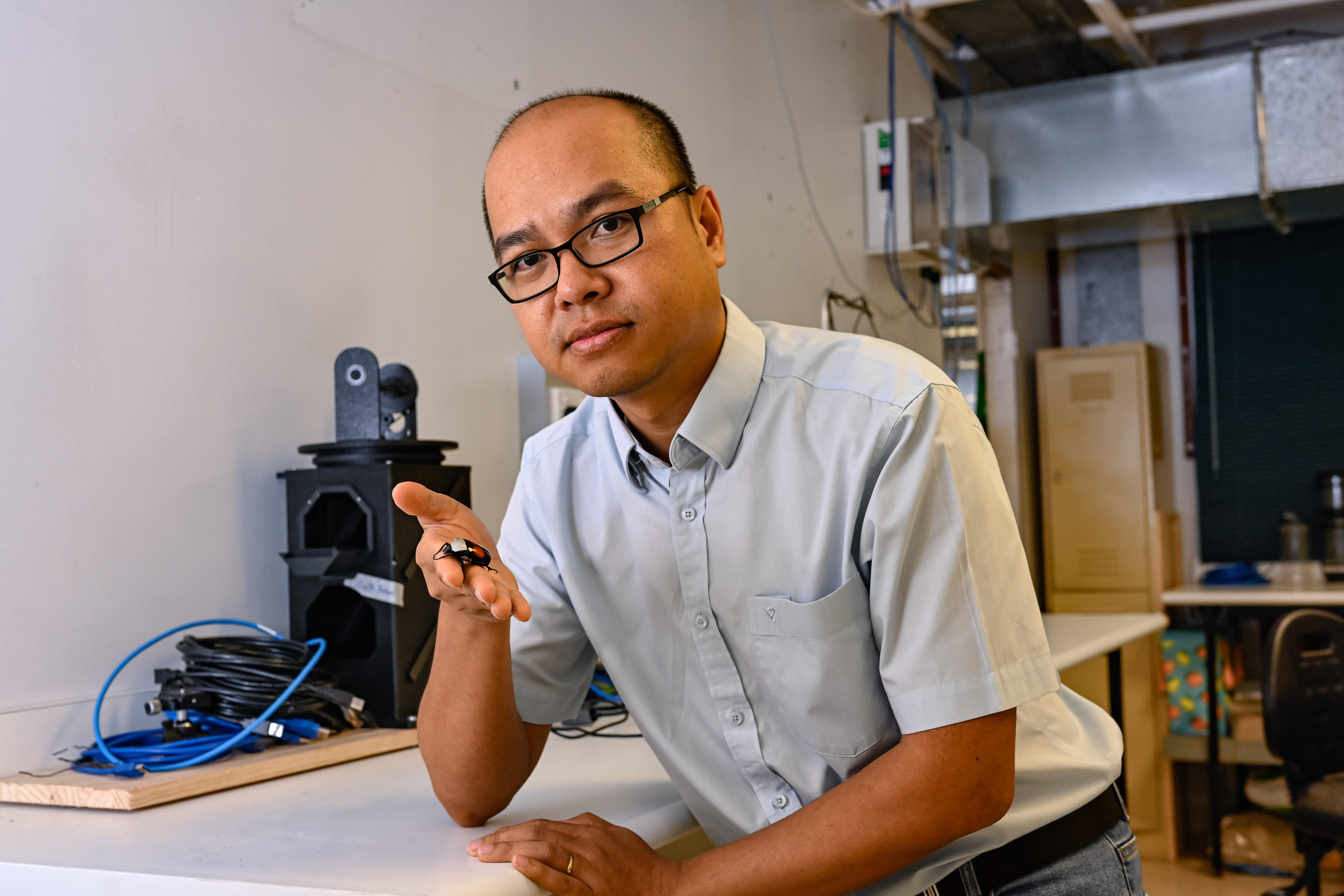 A man holds a beetle