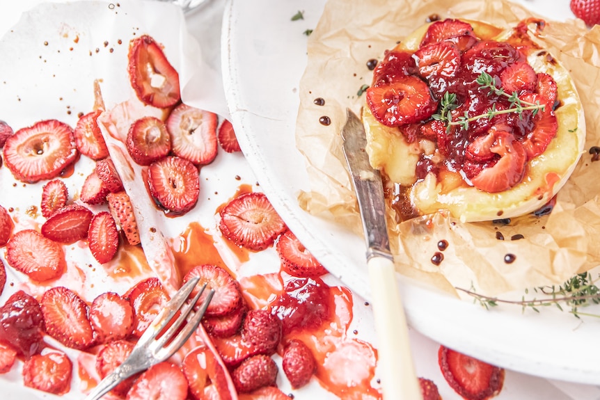 Sliced strawberries with baked brie.