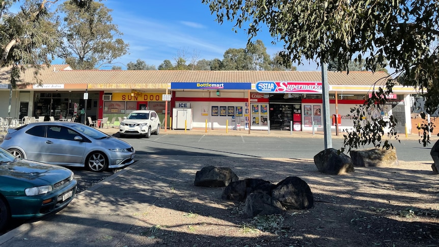 A strip of shops including a cafe, a grocer and a closed up restaurant, in Weston Creek's Duffy.
