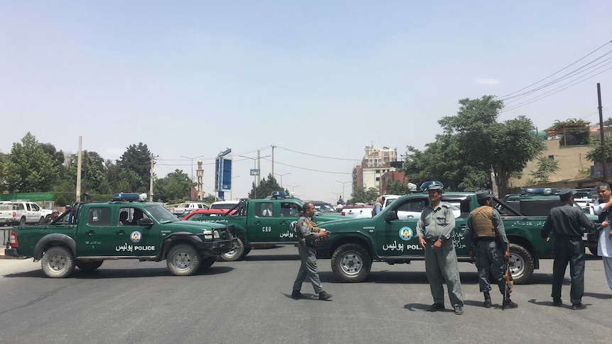 Security personnel block the road with their vehicles