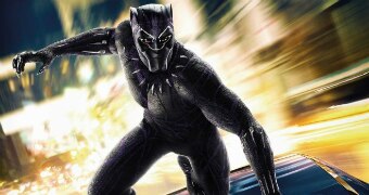 Colour still image of superhero character Black Panther on top of a moving vehicle, the still is from the movie poster.