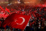 Supporters of Turkish President Tayyip Erdogan wave Turkish national flags during a pro-Government demonstration.