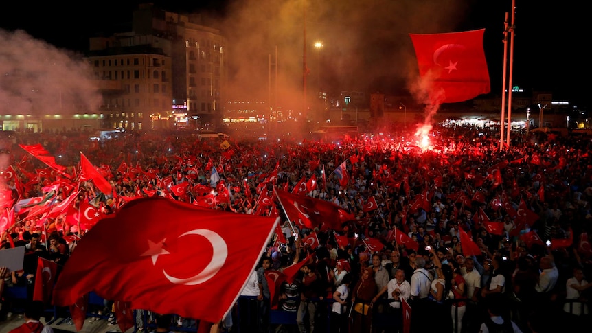 Supporters of Turkish President Tayyip Erdogan wave Turkish national flags during a pro-Government demonstration.