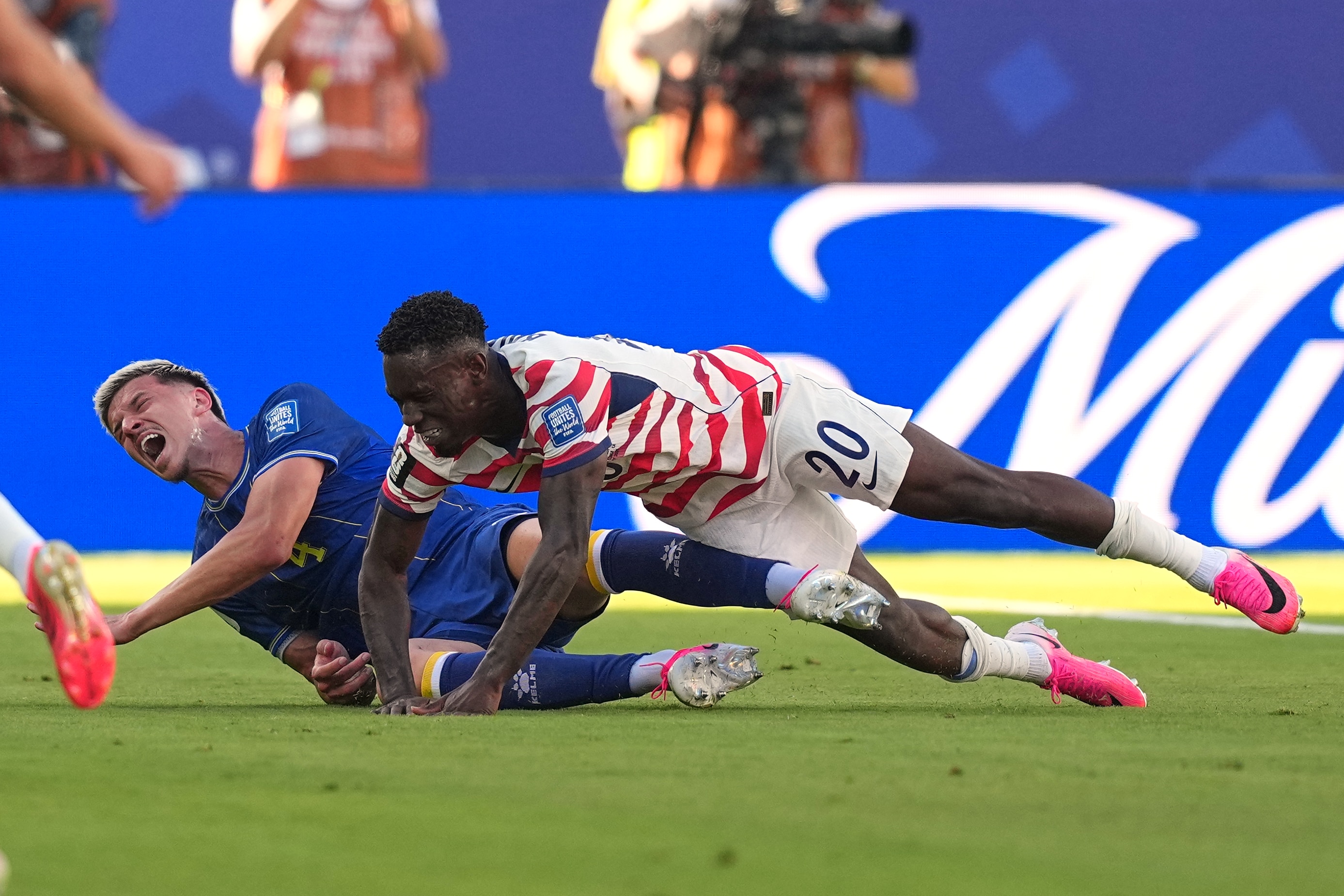 Tarik Muharemović and Folarin Balogun falling to the ground.