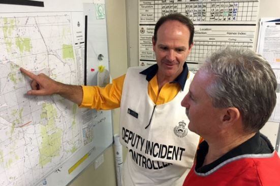 Inspector Andrew Gray points at a map of the area