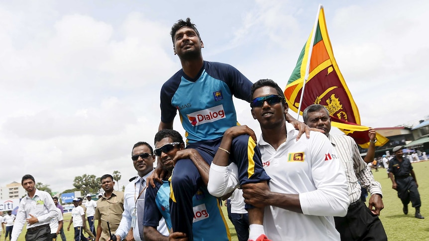 Sri Lanka's Kumar Sangakkara smiles during his retirement ceremony after second Test against India.