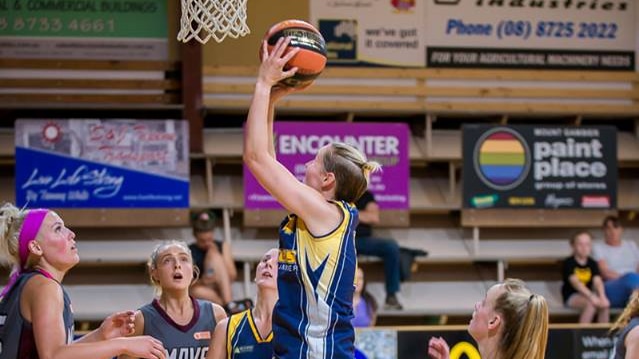 A Mount Gambier Pioneers player in going for a shot during a basketball game