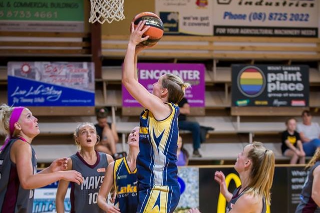 A Mount Gambier Pioneers player in going for a shot during a basketball game