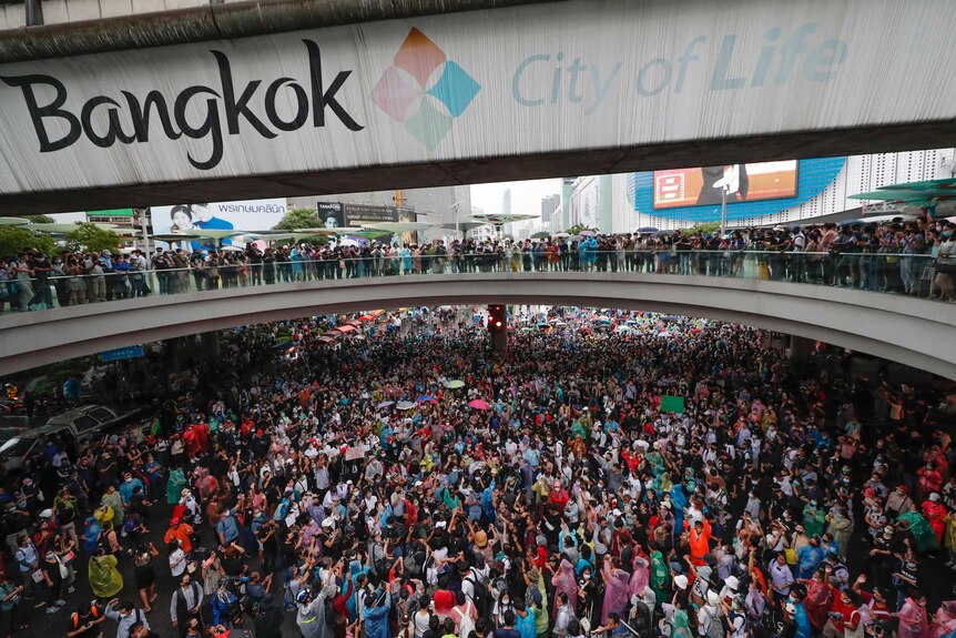 Pro-democracy demonstrators gather in an intersection of a business district in Bangkok.