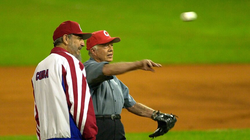 Former US President Jimmy Carter (right) and Cuban leader Fidel Castro warm up on a baseball ground.
