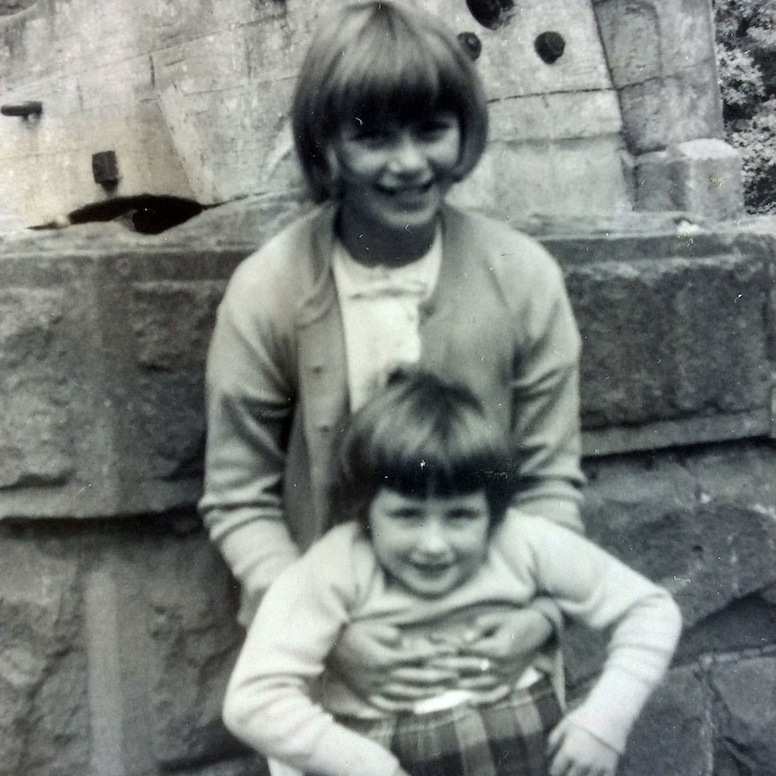 A black and white photo of Cheryl Bihari (rear) with her sister (front) in the 1960s on a rare day trip outside the orphanage.