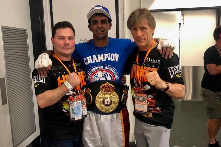 Cameron Hammond stands alongside his trainer