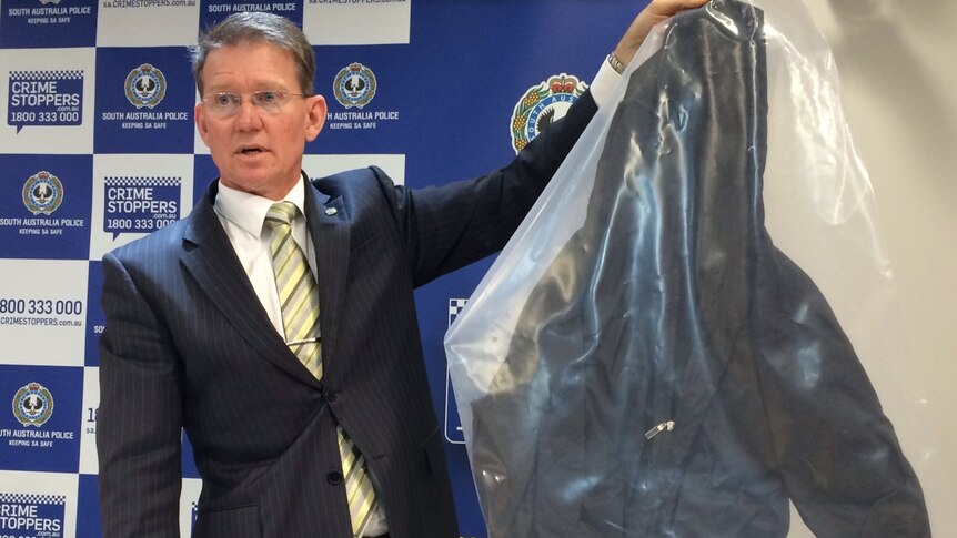 Superintendant Damian Powell with jacket believed to have been worn by attacker at Golden Grove