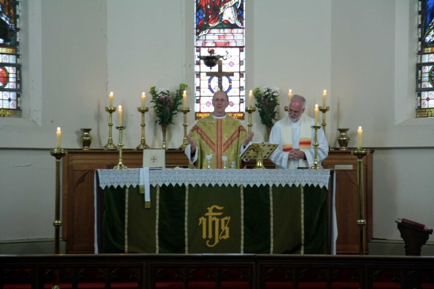 Father Rob Whalley conducting a service with the help of Father John Davis