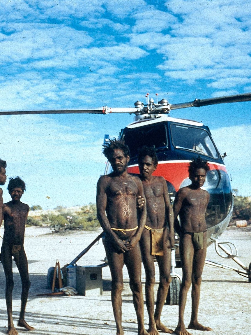 Mr Tjungurrayi's family with the survey helicopter on the Canning Stock Route in 1957