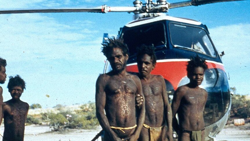 Mr Tjungurrayi's family with the survey helicopter on the Canning Stock Route in 1957