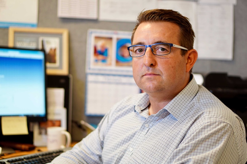 Kevan O'Hare sitting at his desk looking at the camera.