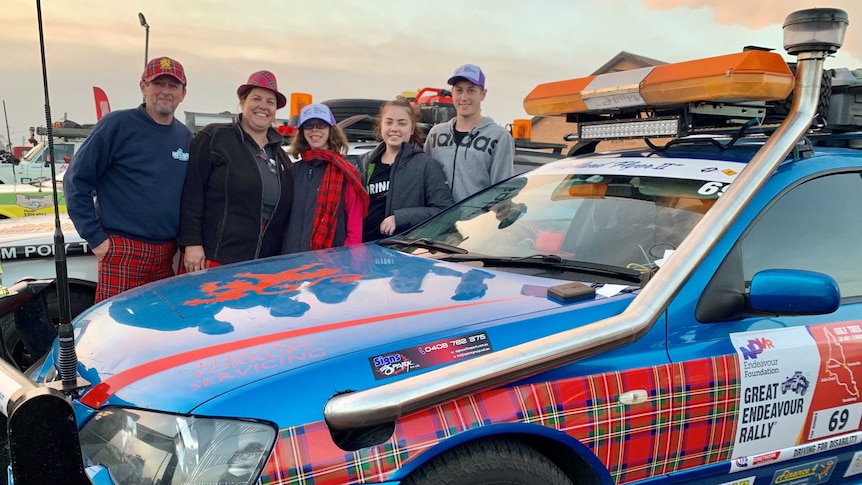 Five people stand with the car they've decorated for the 2019 Great Endeavour Rally