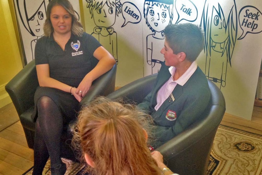 Rural health worker Kate Cross (back to camera) talks with Circular Head Council youth leaders Nakore Popowski (l) and Callum Poke (r)