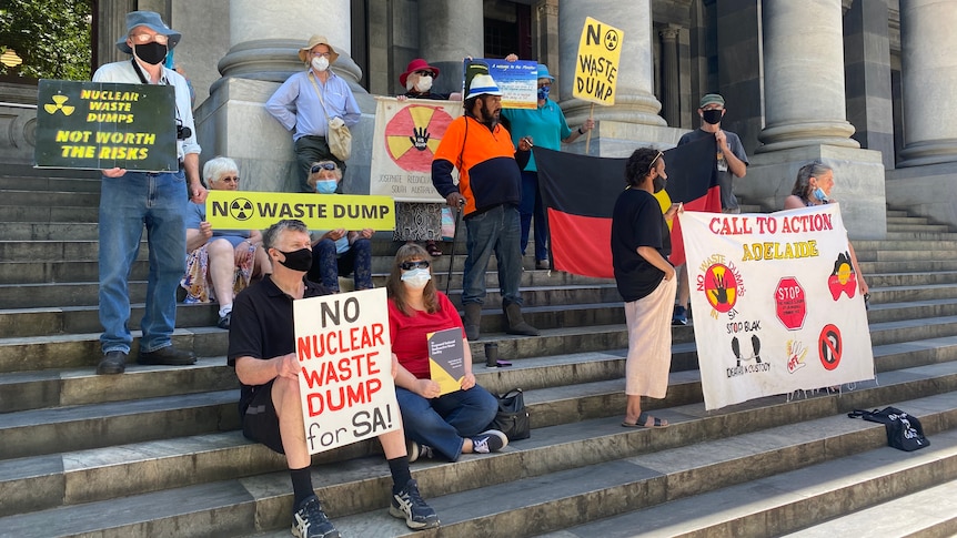 A group of protestors wearing facemasks with signs that read No Nuclear waste dump for SA, Call to Action and No waste dump
