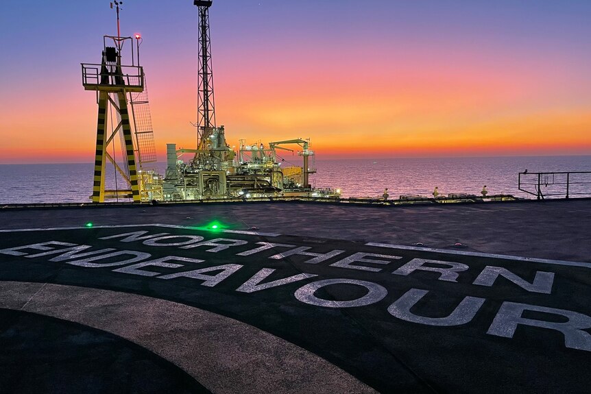 a helipad on a ship called the Northern Endeavour with a sunrise in the background. 