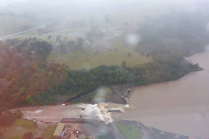 Aerial photo of muddy water gushing through dam wall at Jerrara in the Shoalhaven of New South Wales