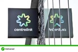 A black square centrelink sign on a building, the sign is reflected in the building