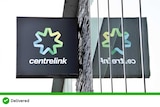 A black square centrelink sign on a building, the sign is reflected in the building