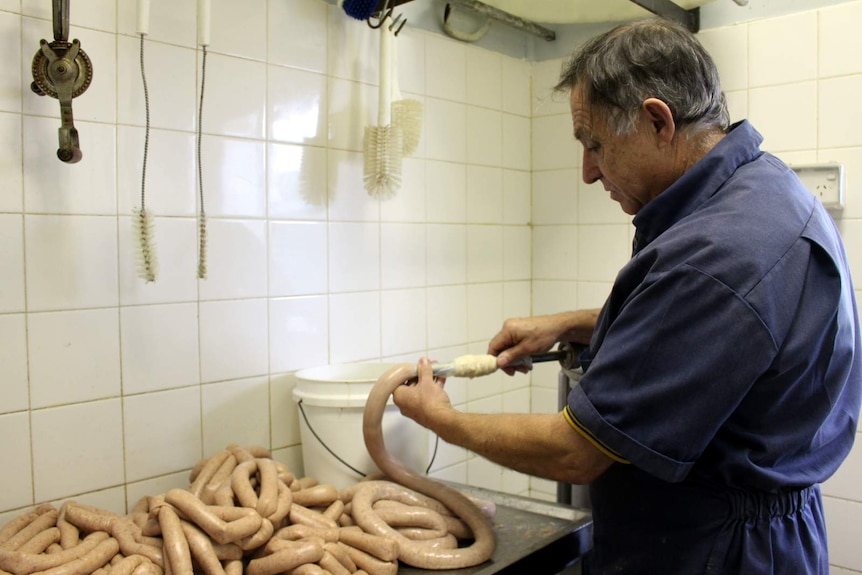 Binalong butcher Mick del Santo making sausages