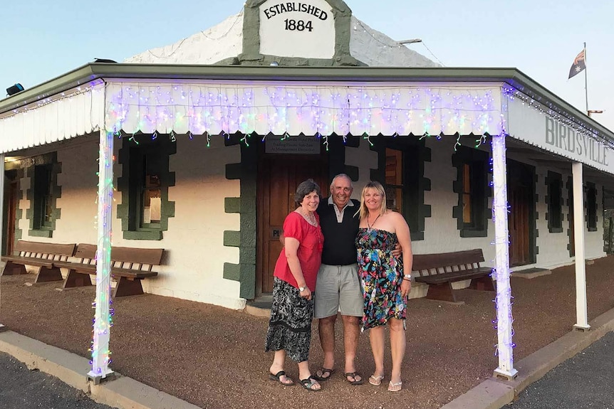 (LtoR) Birdsville locals Bev Morton, Geoff Morton and Kylie Bailey-Hill outside the outback Qld hotel on December 16 2017