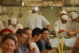 Chefs and customers eating at a restaurant