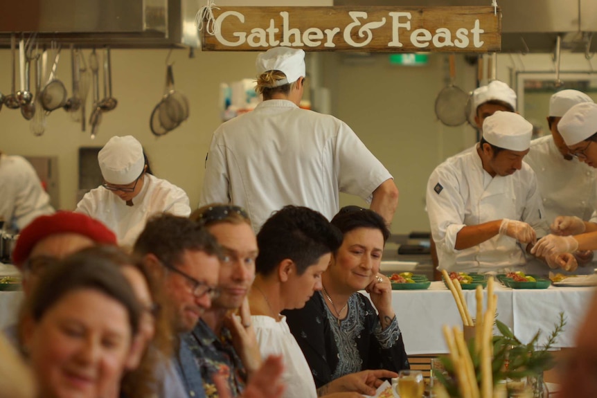 Chefs and customers eating at a restaurant