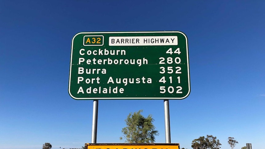 A sign on the Barrier Highway at Broken Hill listing distances to towns towards Adelaide.