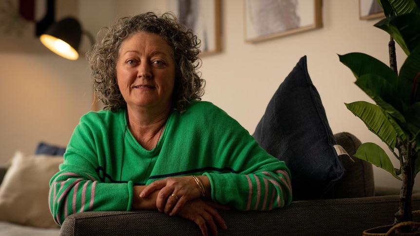 A woman wearing a green top inside a room