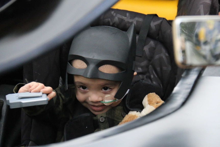 Eli Vale in the Batmobile wearing his Batman mask