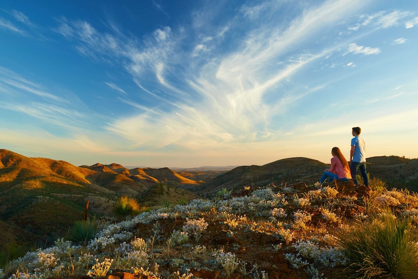 Man and woman looking out over mountainous landscape in Gippsland region in story about regional tourism in droughts.