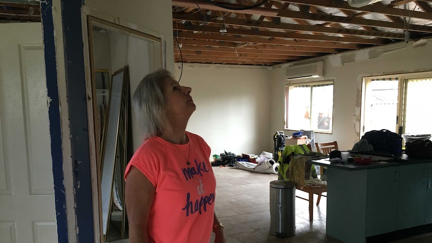 Michelle stands in her home at Kurnell in the wake of a storm that swept through Sydney.
