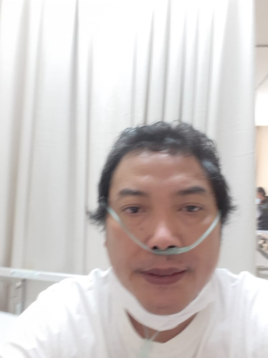 a man with oxygen tube in his nose sitting from a hospital bed