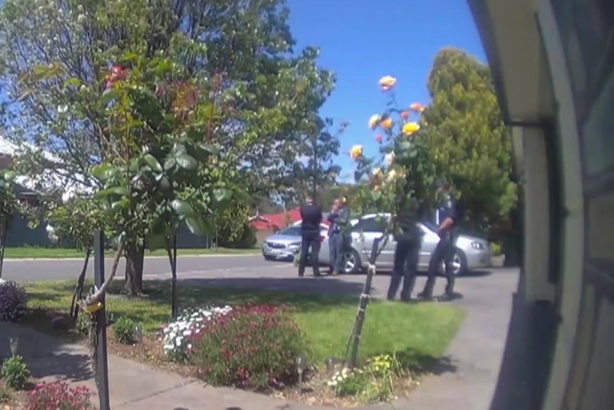 Police standing around outside a house