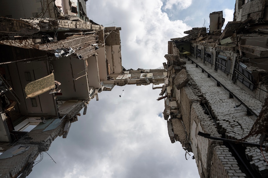 A view from below Mykolaiv Regional Military Administration building shows damage to every floor.