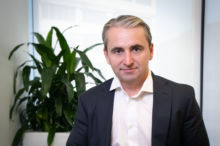 Commonwealth Bank chief executive Matt Comyn looks at the camera in an office setting.