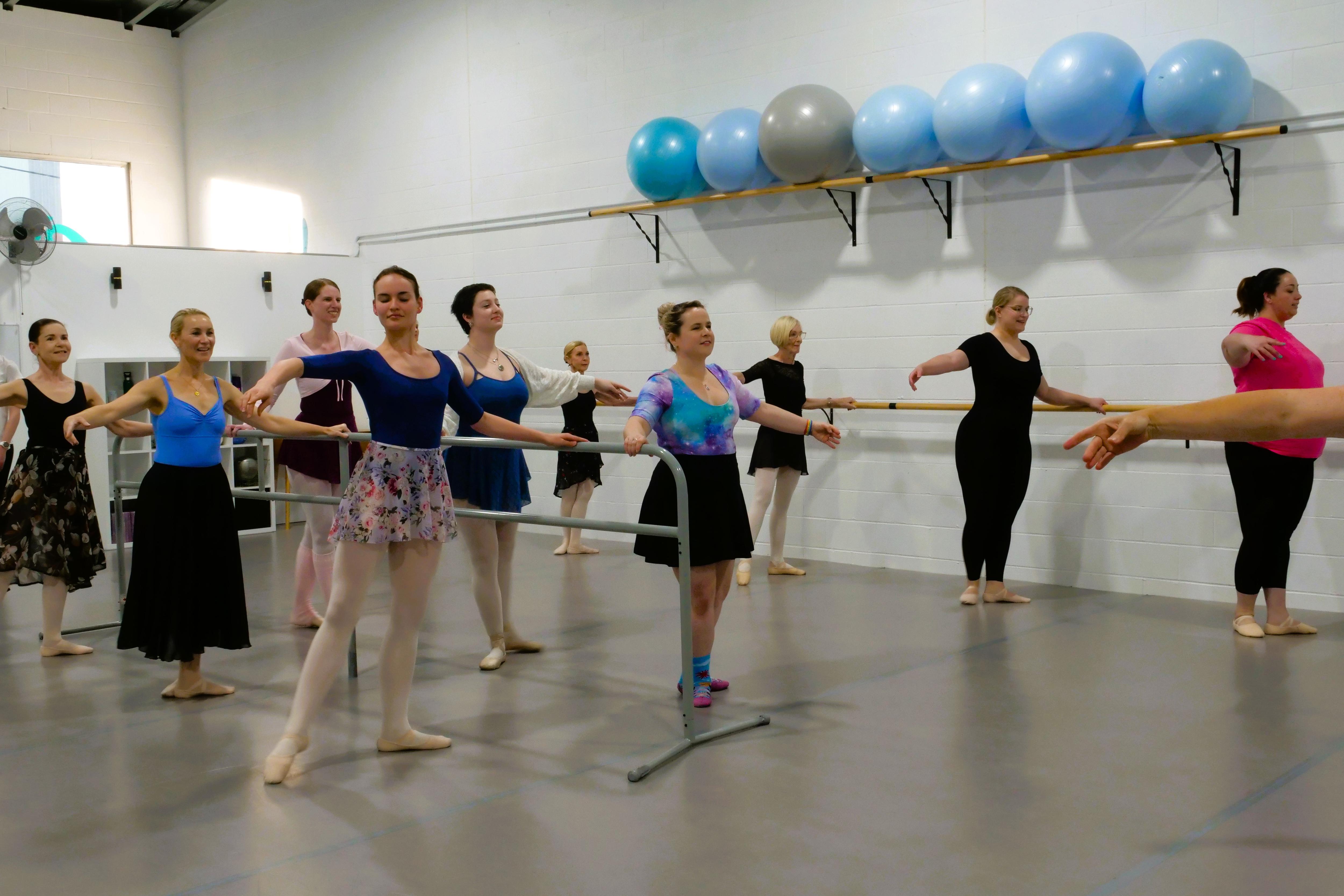 A group of dancers on the bar in the studio. 