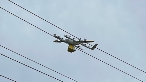 an image of a drone carrying food truck stuck on power lines