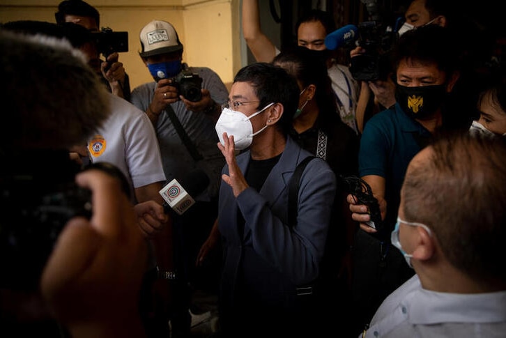 Maria Ressa walks out of Manila City Hall surrounded by media after being found guilty of cyber libel.