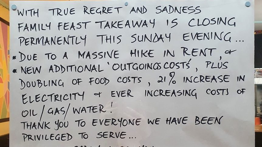 A hand-written sign in black texta on white paper thanking customers for their business and apologising for closing