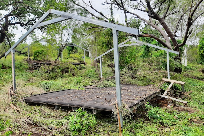 A damaged steel structure lying on the grass